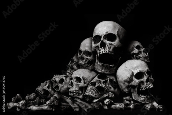 Fototapeta Awesome pile of skull human and bone on black cloth background, concept of scary crime scene of horror or thriller movies,Halloween theme, Still Life style, selective focus,