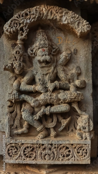 Fototapeta The Carving Sculpture of  Lord Narshimha Cutting the Stomach of Demon Hiranyakshipu, Lakshminarshimha Temple, Javagal, Hassan, Karnataka, India.