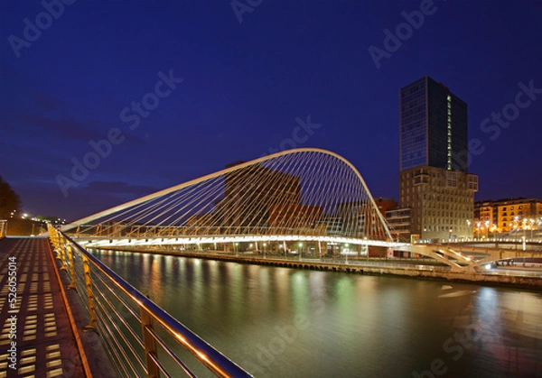 Fototapeta The Zubizuri footbridge (white bridge), also called the Campo Volantin Bridge, across River Nervion, Bilbao, Spain