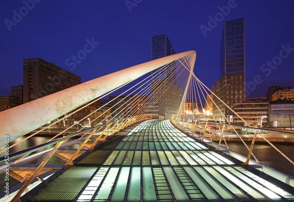 Fototapeta The Zubizuri footbridge (white bridge), also called the Campo Volantin Bridge, across River Nervion, Bilbao, Spain