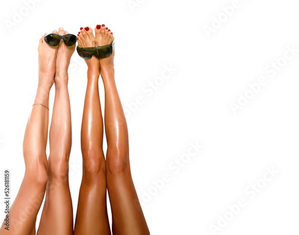 Obraz beautiful pairs of smooth woman's legs after laser hair removal with protection glasses for laser removal on the white background