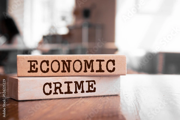 Fototapeta Economic Crime text concept written on wooden blocks lying on a table