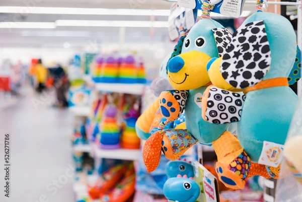 Fototapeta Shop toy store for babies. A soft toy close-up on a shopping trip with a blurry background.