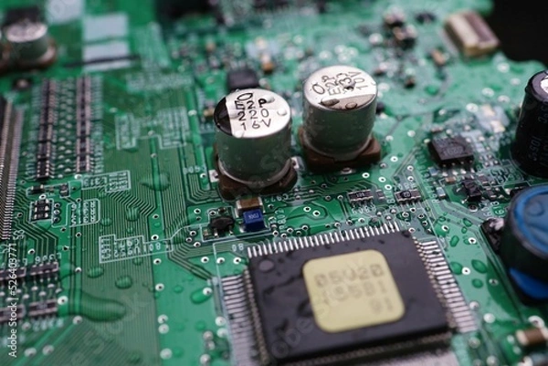 Fototapeta A semiconductor on a printed circuit board wet from the rain.Image: recession, bankruptcy.