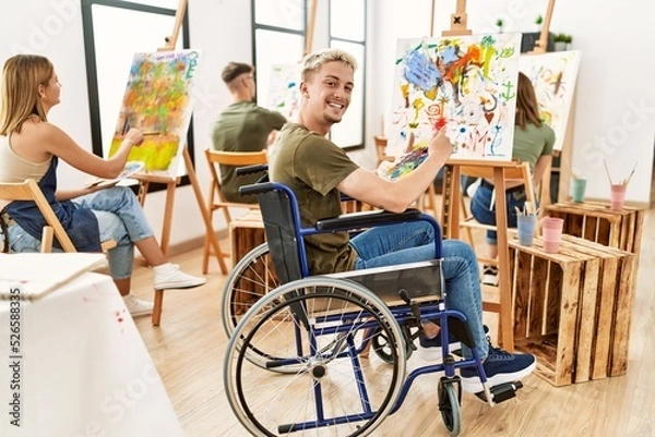 Fototapeta Group of people drawing at art studio. Young man sitting on wheelchair.