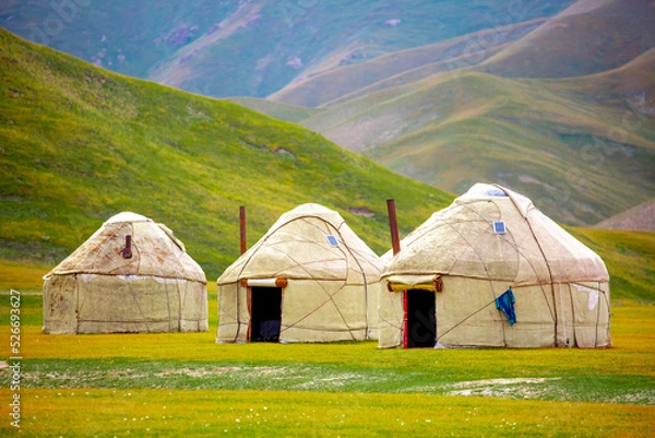 Fototapeta Yurt. National old house of the peoples of Kyrgyzstan and Asian countries. national housing. Yurts on the background of green meadows and highlands. Yurt camp for tourists.