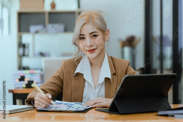 Fototapeta Businesswoman working with calculator and laptop computer at office workplace, finance marketing chart, Business digital technology and marketing concept.