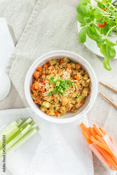 Fototapeta mouthwatering Pearl barley with carrot, celery and zucchini on white background