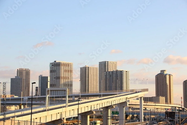 Fototapeta Buildings and highway at dusk