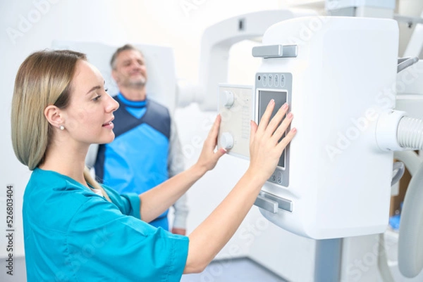 Fototapeta Smiling patient waiting for the x-ray machine to turn on
