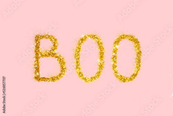 Fototapeta Shiny Halloween boo concept. Golden glitter on pastel light pink background. Minimalistic holiday party composition.