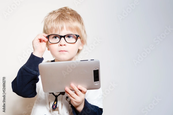 Obraz Little boy reading on tablet pc