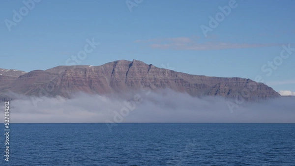 Fototapeta Mountain in fog in Greenlandic fjord