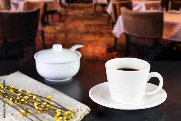 Obraz international coffee day, traditional colombian drink, mug of coffee and sugar with flowers on a restaurant table