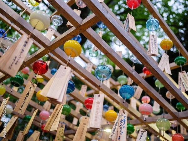 Fototapeta Colorful wind chimes blowing in the wind to celebrate love at a Japanese shrine