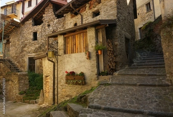 Fototapeta View of a glimpse of a small square among the alleys of the historic center of the ancient village of Careno,early in the morning . Lake Como, Italy.