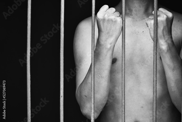 Obraz prison man crime in gaol raised his fist and two arms demonstrates confidence and courage.concept for prisoner,hopeness,detain,erroneousness