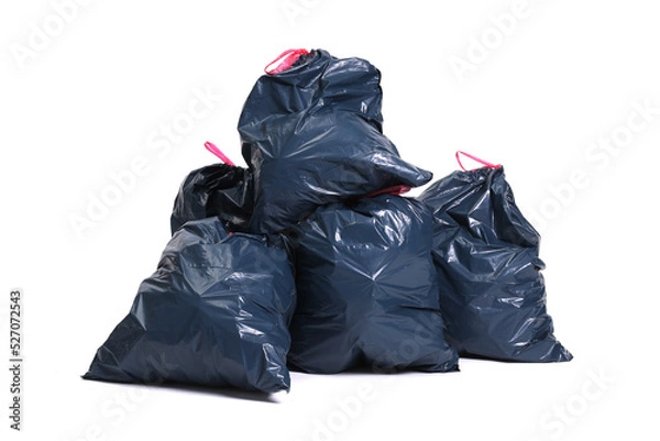 Fototapeta Many big black plastic bags for trash waste placed on a white background