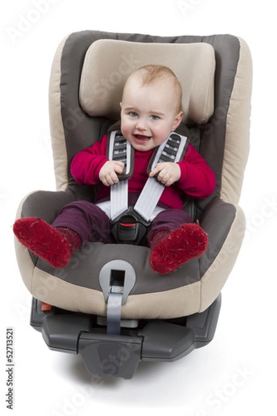 Fototapeta child in booster seat for a car in light background