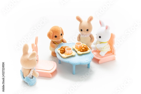 Obraz Miniature dollhouse furniture isolated on white background. Animal doll. Kids toy. Play and learn. Kids room. Childhood. Kindergarten toy. Developmental toys. Tiny dining table. Cute doll.
