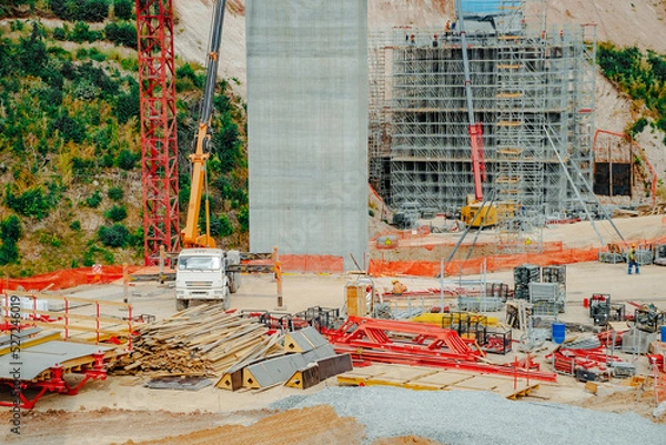 Fototapeta  Constructing concrete pillars of the bridge. Construction of the new M12 highway