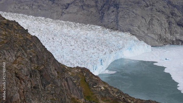 Fototapeta Calving iceberg from a mountain near Narsarsuaq