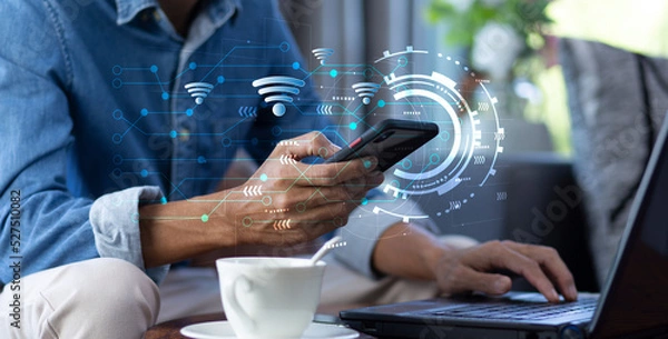 Fototapeta hand of man using smartphone with open wifi network connection while work at home or cafe