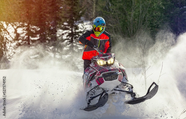 Obraz Snowmobile riding with fun in deep snow powder during backcountry tour. Extreme sport adventure, outdoor activity during winter holiday on ski mountain resort