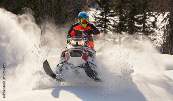 Fototapeta Snowmobile riding with fun in deep snow powder during backcountry tour. Extreme sport adventure, outdoor activity during winter holiday on ski mountain resort