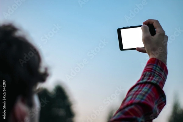 Obraz person taking picture of themselves with phone
