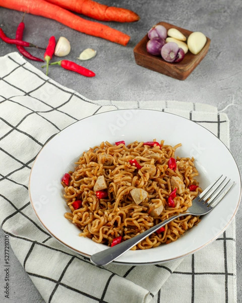 Fototapeta Favorite dish stir fried noodles or locally known as MIe Goreng. Selective focus.