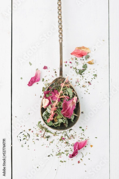Fototapeta Herbal tea. Detox. Dry tea on a vintage spoon and a white background. Top view. Flatlay