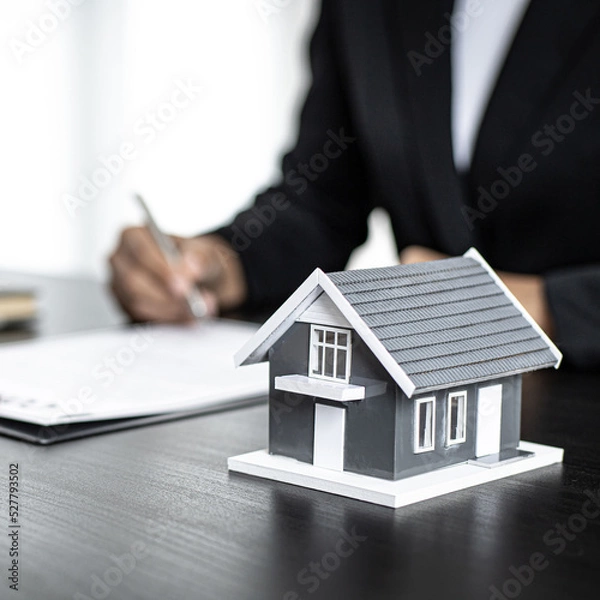 Fototapeta Real estate agent talked about the terms of the home purchase agreement and asked the customer to sign the documents to make the contract legally, Home sales and home insurance concept.