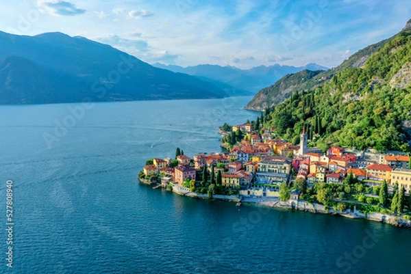 Fototapeta Village of Varenna on Como lake in Italy. Varenna by Lake Como in Italy, aerial view of the old town with the church of San Giorgio in the central square. Famous mountain lake in Italy