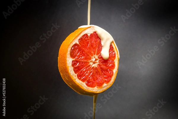 Obraz Fresh grapefruit with water yogurt drops. isolated dark background