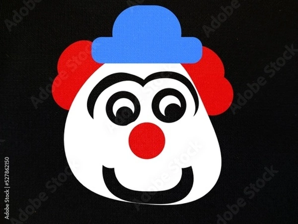 Fototapeta illustration or abstract background image, a clown head with red hair and wearing a blue hat on a black background