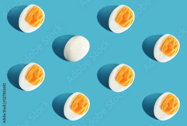 Obraz Difference pattern slice boiled eggs on blue background. Think different concept and business success idea