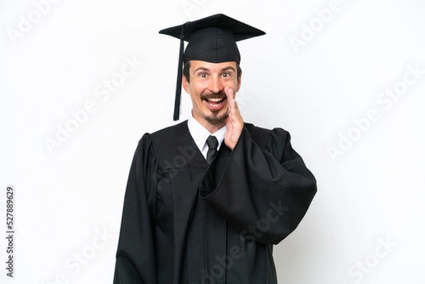 Obraz Young university graduate man isolated on white background with surprise and shocked facial expression