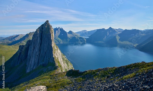 Fototapeta View from the mount Hesten on iconic mountain Segla in a summer sunny day. Mountain ranges at the background. Fjordgard, Senja island, Norway. Summer vacation in Lofoten   