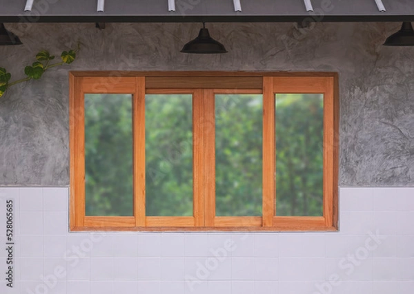Fototapeta Background of glass and wooden sliding window with hanging lamps on concrete and white tile wall of vintage restaurant