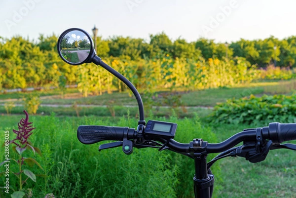 Fototapeta Bicycle rear view mirror with nature reflection.