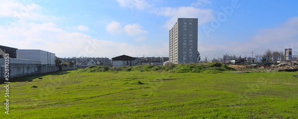 Fototapeta New apartement building tower in front of wasteland in a recently developping area in Talca, Chile