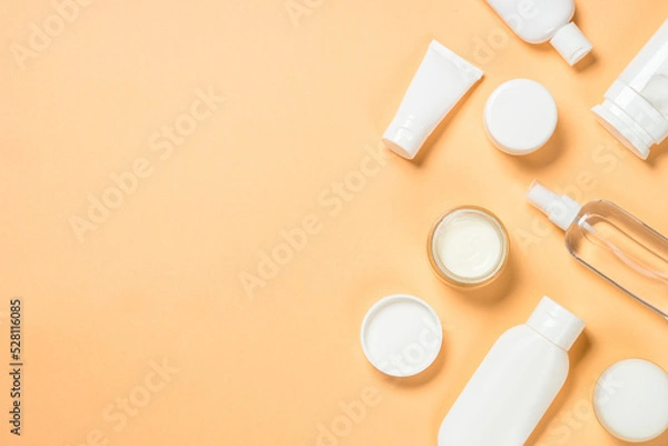 Fototapeta Natural cosmetic products. Cream, mask, tonic and lotion for skin care. Flat lay image at color background.