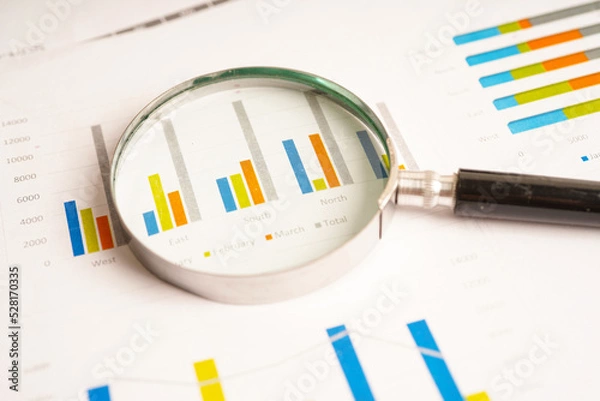 Obraz Magnifying glass on charts graphs paper. Financial development, Banking Account, Statistics, Investment Analytic research data economy.