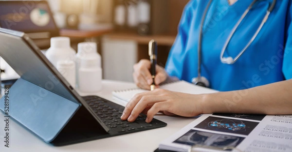 Fototapeta Medical technology concept. Doctor working with tablet keyboard mobile phone and stethoscope