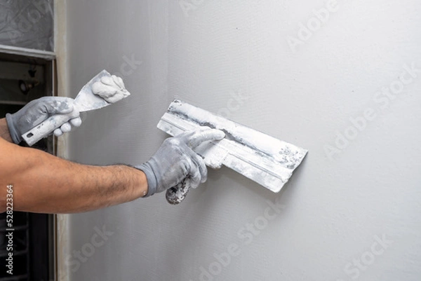 Obraz Plasterer applies plaster on the wall during repair and restoration work