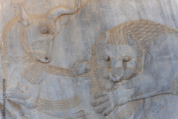 Fototapeta Bas-relief decoration along stairs from Darius palace to Palace of Xerxes. Ancient ruins of Persepolis near Shiraz in southern Iran. This UNESCO World Heritage Site showcases beautiful ruins from the 
