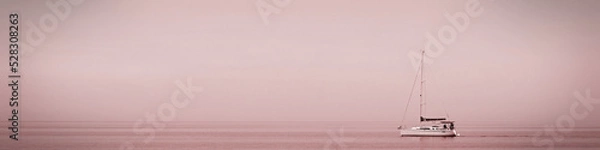 Fototapeta Universal banner 4x1 for websites, social networks and typography boat on the quiet surface of the sea at sunset