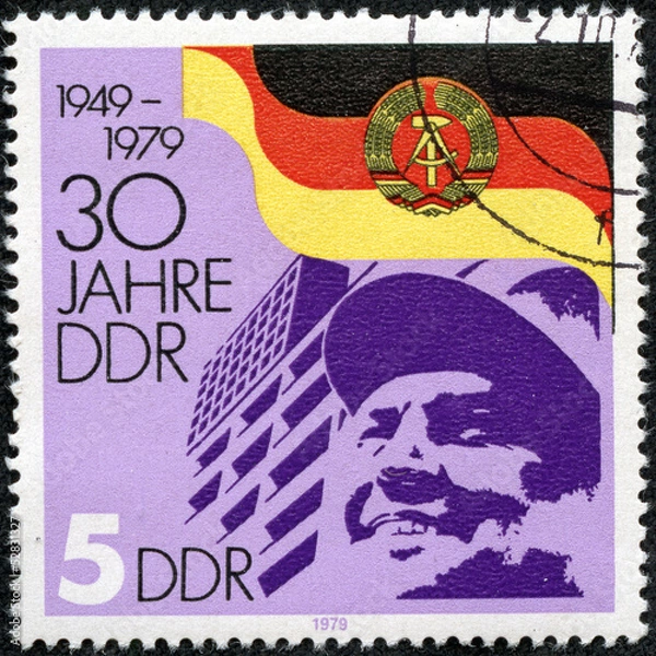 Fototapeta stamp printed by Germany, shows DDR Arms and Flag Worker