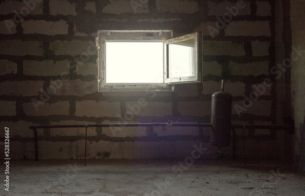 Obraz A small bright window with an open sash inward. The light from the window illuminates the twilight of the service room, the roughly putty block walls and the metal structure of the pipe and tank.